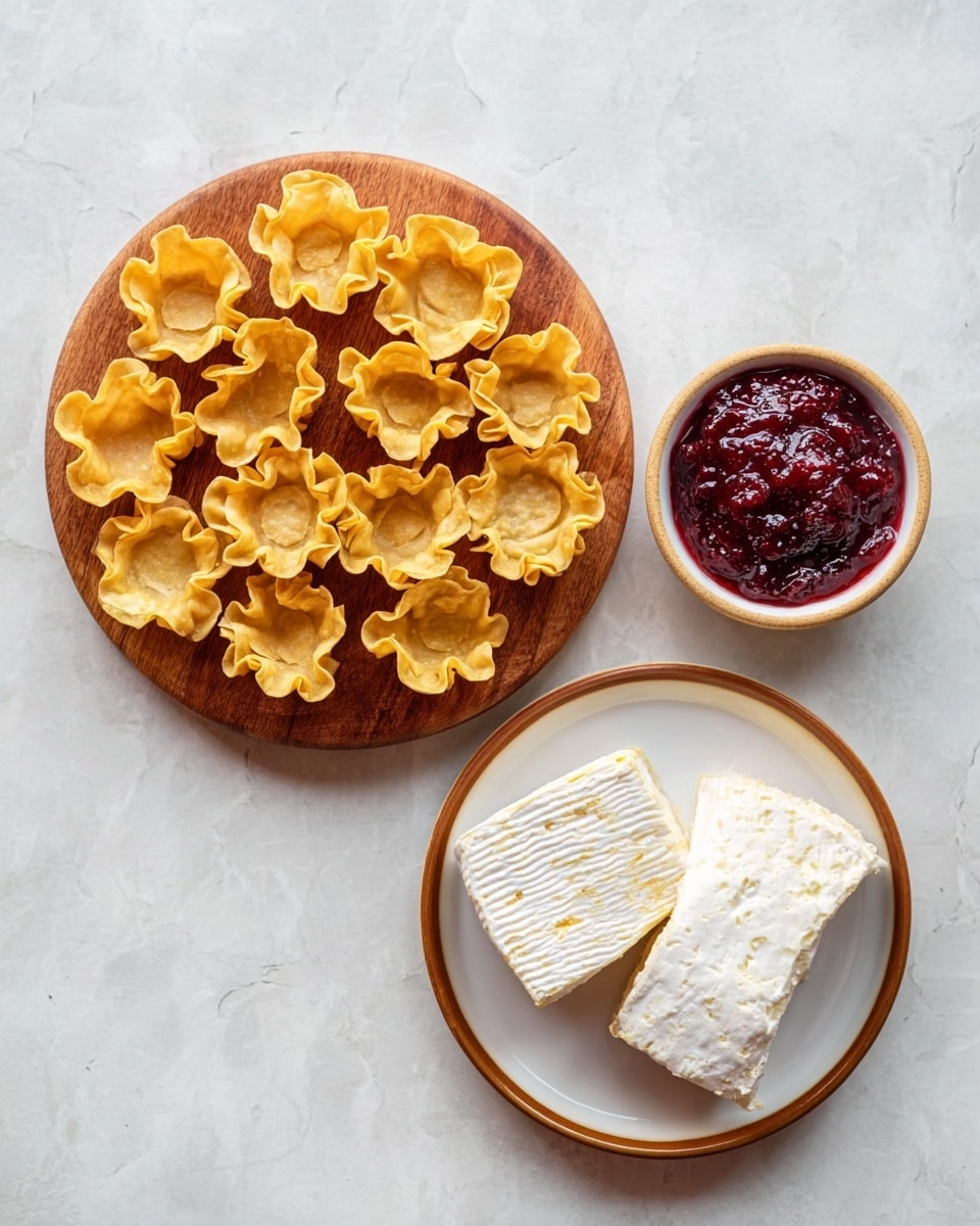 The image shows a baking tray filled with golden brown, crispy phyllo cups, each holding melted creamy cheese at the base, topped with a dollop of bright red cranberry sauce. A small green rosemary sprig decorates the top of each cup, adding a fresh contrast to the warm colors. The tray sits on a white marbled surface with scattered fresh cranberries and rosemary sprigs nearby. A white bowl with more cranberry sauce sits to the side, adding a rich red element to the scene. The overall look is warm, inviting, and festive, with soft texture details on the phyllo edges and glossy cranberry sauce. photo taken with an iphone --ar 4:5 --v 7