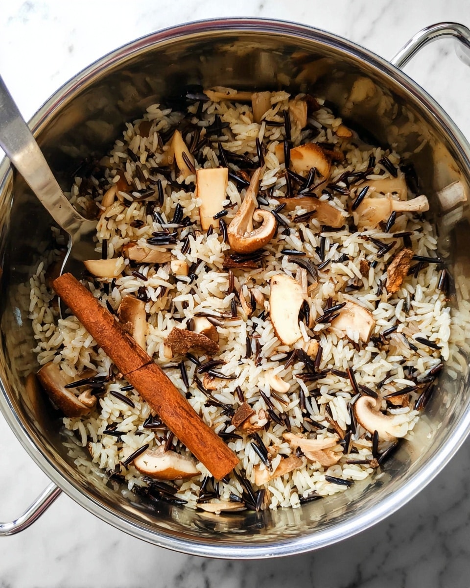 A shiny, roasted pumpkin with a deep orange color is used as a bowl with its top lid slightly lifted to show the filling inside. The filling has three layers: the bottom layer is light brown rice, the middle layer is dark brown toasted pecans, and the top layer is red pomegranate seeds mixed with small green herb pieces. The pumpkin sits on a simple white marbled surface, placed on a round white plate. Scattered around are some pecans, a few pomegranate seeds, and green herb leaves, adding a natural touch. In the background, a black bowl with more the same mixture is slightly blurred, adding depth. photo taken with an iphone --ar 4:5 --v 7