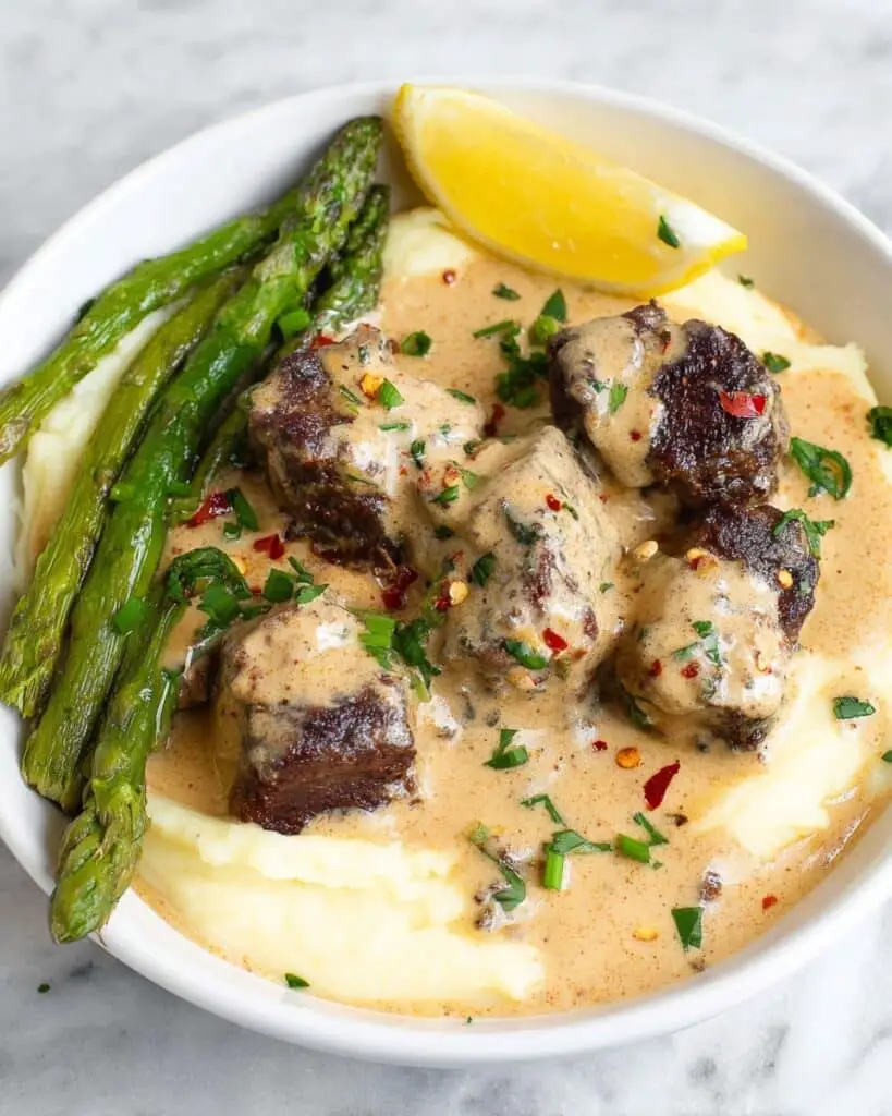 Garlic Butter Steak Bites with Parmesan Cream Sauce & Cheesy Mashed Potatoes Recipe