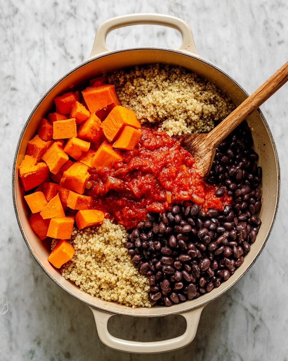 The image shows a large round white pot with two side handles, filled with four visible layers of ingredients arranged separately inside. In the top left section, there are bright orange cubes of sweet potato. To the right, a pile of cooked light beige quinoa with a fluffy texture sits next to the sweet potatoes. Opposite the sweet potatoes, there is a mound of shiny, dark black beans. Below the black beans, there is a layer of vibrant red tomato sauce with a slightly chunky texture. A wooden spoon rests on the right side inside the pot, touching the quinoa. The pot sits on a white marbled surface. Photo taken with an iphone --ar 4:5 --v 7