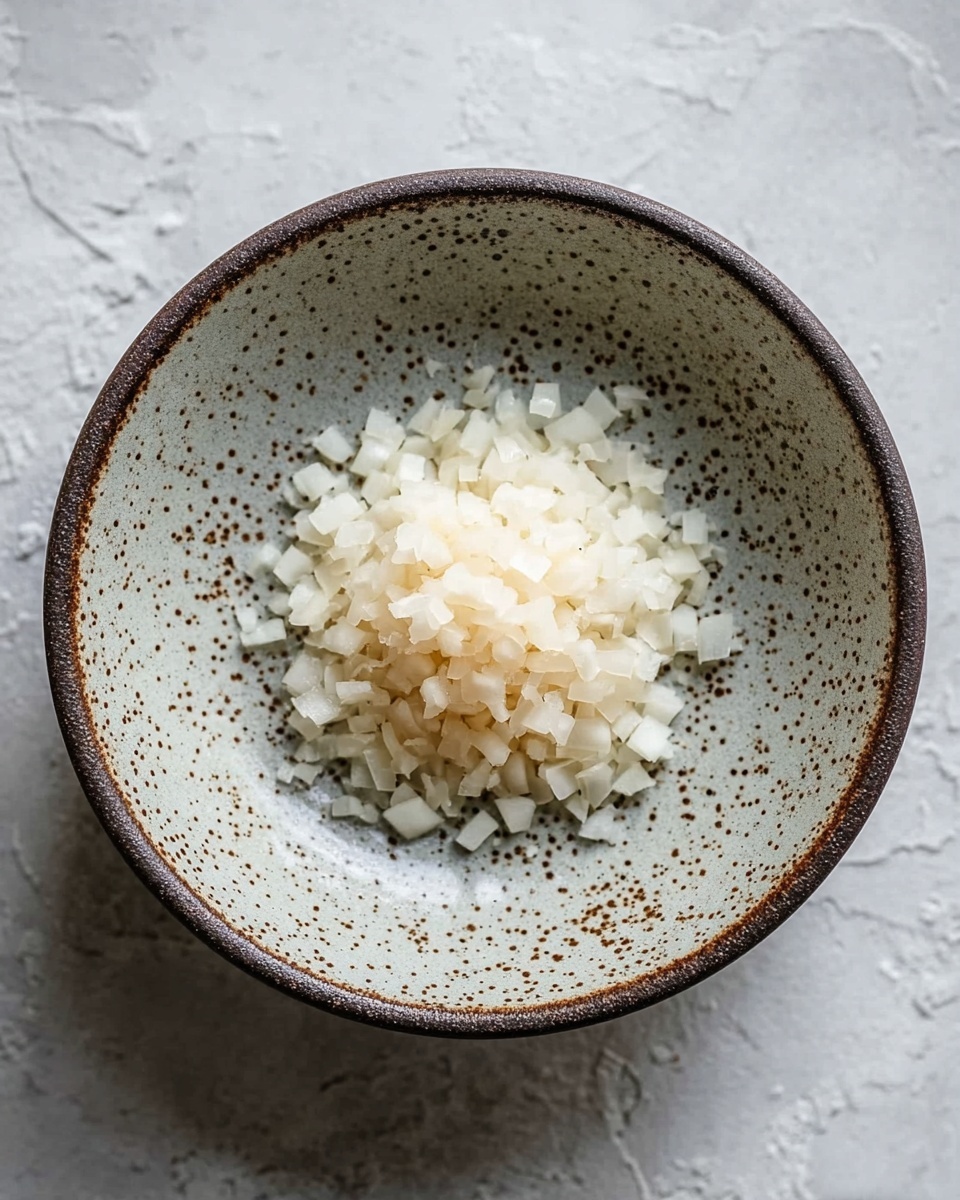 A rustic wooden cutting board on a white marbled surface holds a heap of finely chopped bright green herbs spread in the center. To the right side of the board is a large kitchen knife with a shiny silver blade and a wooden handle with three metal rivets. There are a few scattered whole herb leaves around the board adding a natural touch to the scene. photo taken with an iphone --ar 4:5 --v 7