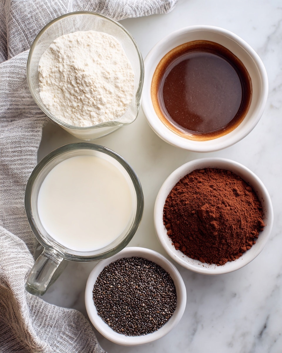 The image shows five small containers of ingredients on a white marbled surface. There is one clear glass measuring cup filled with white milk at the bottom left. Above it are two small white bowls: one with dark brown liquid and the other with a slightly lighter brown liquid, both shiny and smooth. To the right, there is a white bowl filled with fine, dark brown cocoa powder with a soft texture. Next to it, another white bowl contains small, dark chia seeds with a slightly rough texture. A light gray and white striped cloth is partially visible at the bottom left corner. photo taken with an iphone --ar 4:5 --v 7