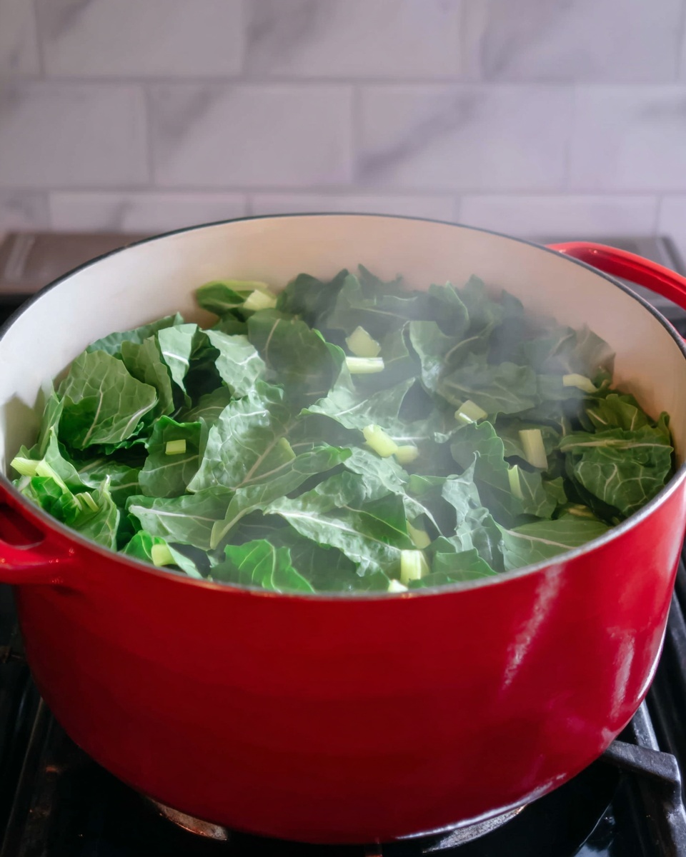 A red pot with a white inside is filled with bright green leafy vegetables that are steaming, showing a fresh and soft texture. The leaves fill the pot almost to the top with varying shapes and veins visible, mixed with small chunks of light green stems. Steam rises, slightly blurring the upper part of the greens, creating a warm and fresh cooking scene. The pot sits on a black stovetop with a white marbled wall in the background photo taken with an iphone --ar 4:5 --v 7