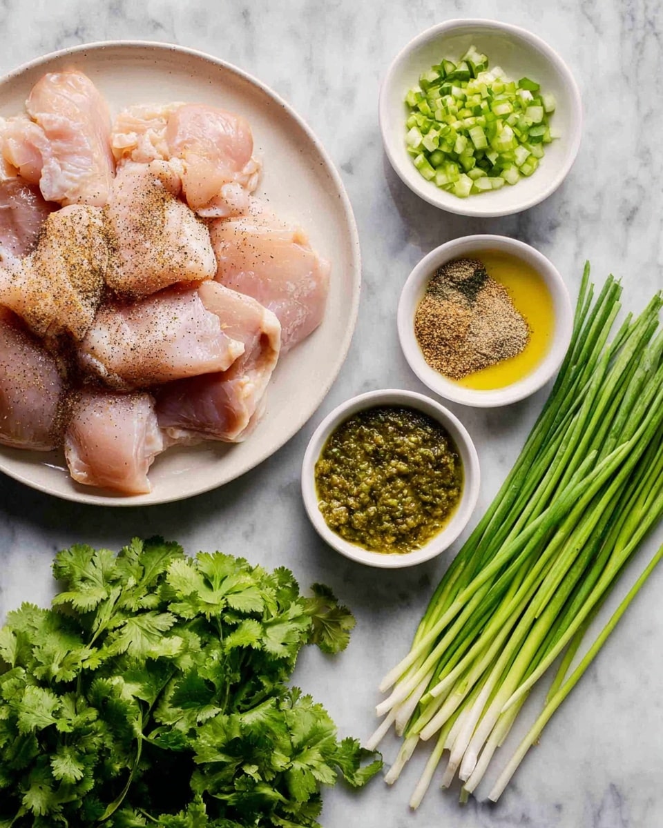 The image shows a white plate filled with raw chicken pieces that are sprinkled with black pepper. To the right of the plate, there are three small white bowls: one with chopped garlic and green chilies, one with mixed spices in three sections, and one with green salsa. Below the plate is a bunch of fresh green cilantro, and to the right of the cilantro, there are several long, green onions neatly arranged on a white marbled surface. photo taken with an iphone --ar 4:5 --v 7