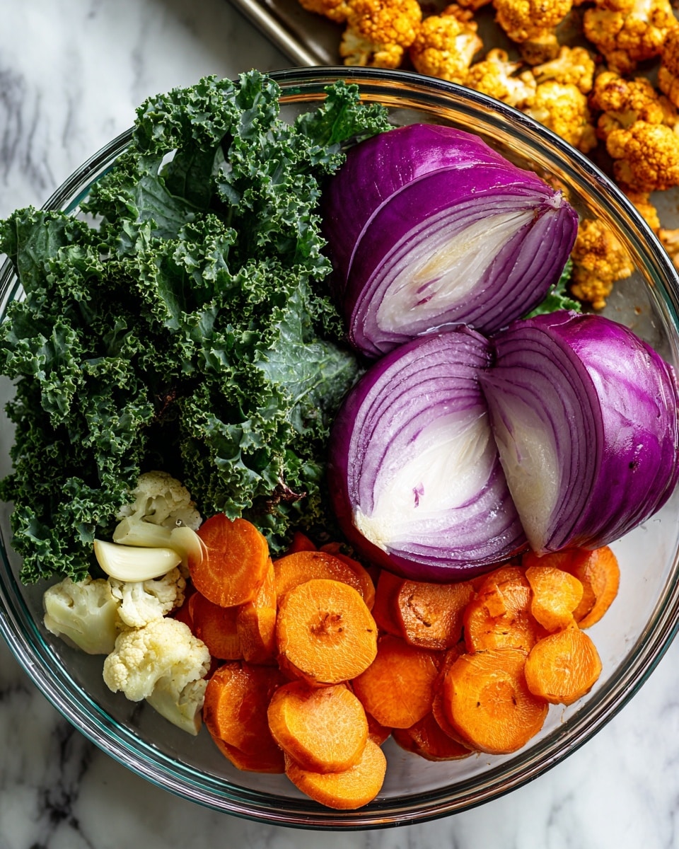 A clear glass bowl holds a colorful mix of fresh vegetables on a white marbled surface. Inside the bowl, there are bright green curly kale leaves positioned on one side, beside two halves of a purple and white onion resting flat. Scattered near the kale and onions are several thick slices of vibrant orange carrots and a few whole garlic cloves. In the background, a baking sheet filled with small, golden roasted cauliflower florets sits slightly out of focus. Photo taken with an iphone --ar 4:5 --v 7