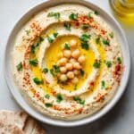Creamy Homemade Hummus with Olive Oil, Paprika, and Parsley Recipe