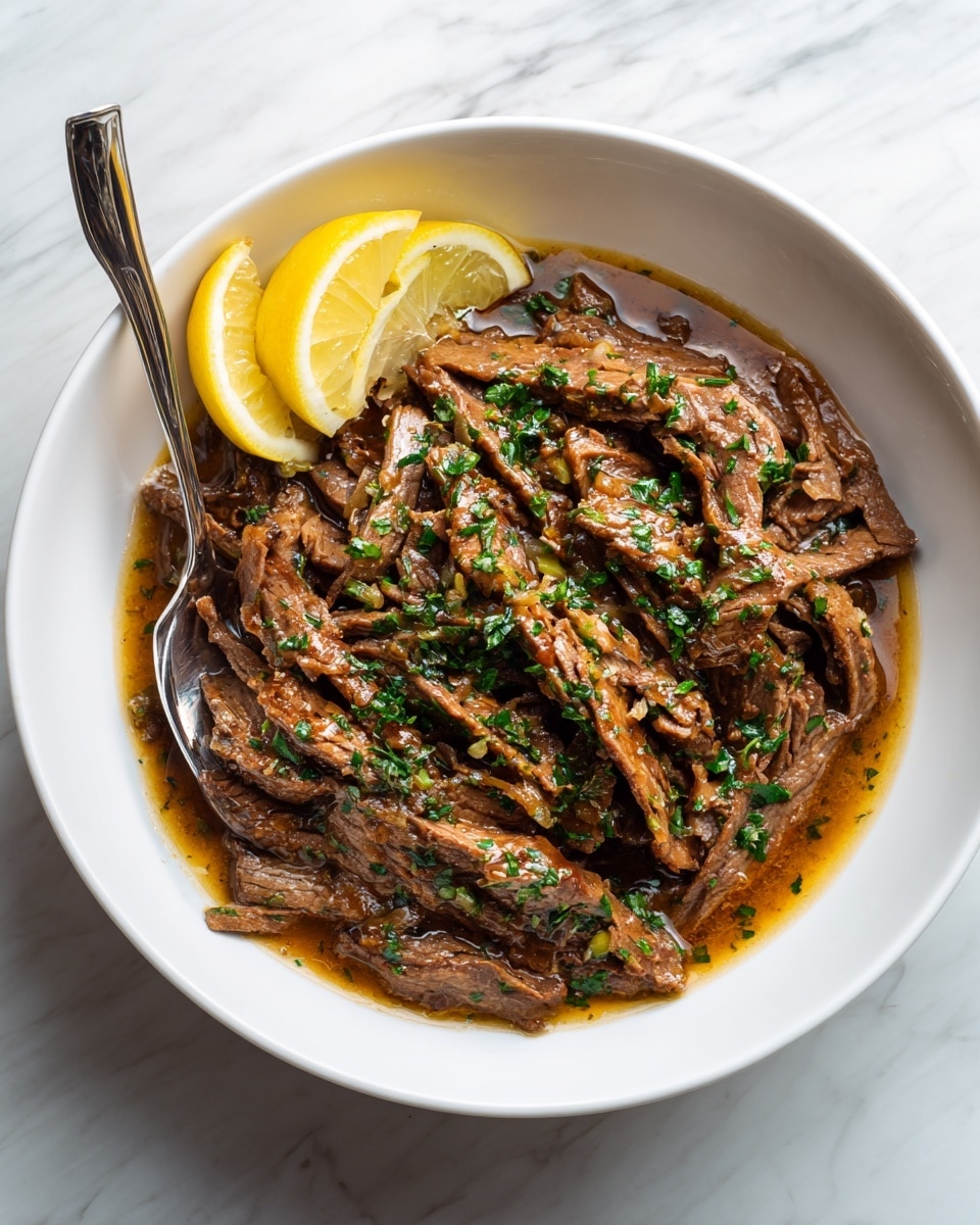 The image shows a white bowl filled with several long, thin, brown strips of cooked meat covered in a thick, shiny, brown sauce with small green herb pieces sprinkled on top. At the top left edge inside the bowl, there are two pale yellow lemon wedges. A silver fork is placed inside the bowl slightly to the left, with its handle resting on the white marbled surface below. The sauce looks rich and glossy, pooling around the meat strips, creating a warm and inviting texture photo taken with an iphone --ar 4:5 --v 7