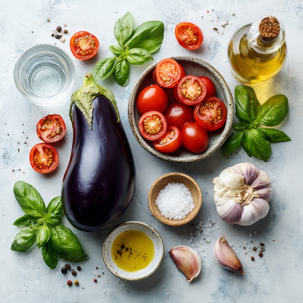 A dish served on a white plate with blue floral patterns, filled with a mix of diced, soft eggplants in dark purple and pale tan colors and bright red cooked tomatoes, all coated in a slightly thick red-orange sauce. Fresh green basil leaves are scattered on top in three places, adding a fresh look. The plate is placed on a wooden surface with a rustic texture, and more basil leaves lie beside it. The colors create a warm and fresh feeling. Photo taken with an iphone --ar 4:5 --v 7
