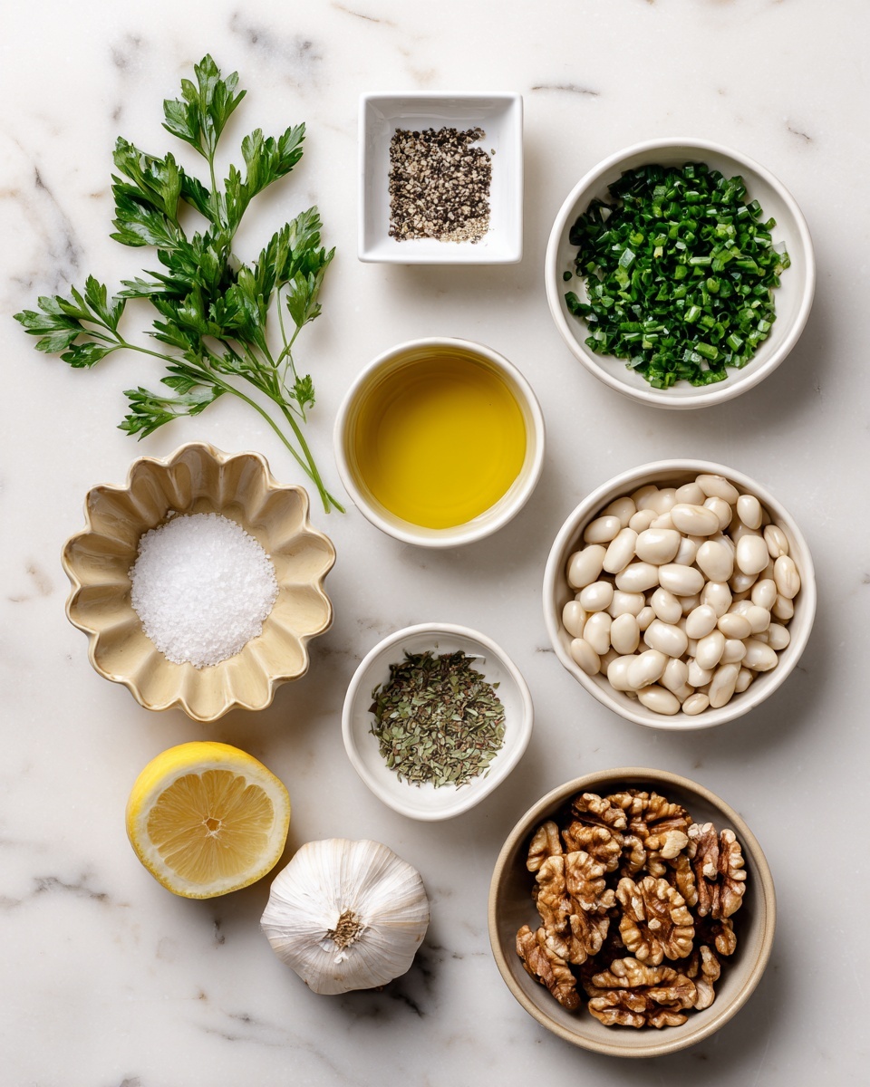 A close-up of a white bowl filled with creamy light green dip that has a thick, slightly chunky texture, topped with a drizzle of olive oil and sprinkled with chopped fresh dark green herbs. A woman's hand is dipping a triangular, lightly browned crisp chip into the dip, scooping up a small amount. The bowl is set on a white marbled surface with a lemon wedge blurred in the background. Photo taken with an iphone --ar 4:5 --v 7