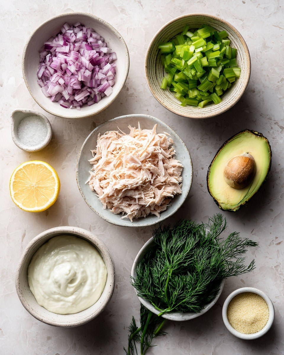 The image shows seven small white bowls and dishes arranged on a white marbled texture. Starting from the top left, a small bowl holds finely chopped purple onions. To its right, a larger bowl contains small green celery pieces. Below and slightly right of the celery, a small white measuring cup is filled with thick white yogurt. Centered in the image is a bowl of light beige shredded salmon. To the left of the salmon is a half lemon showing a bright yellow interior. Below the lemon is a bowl filled with dark green fresh dill. To the right of the dill is a half avocado with a light green inside and a dark green outer skin. Below the avocado to the right is a small dish with pale yellow powder. The bowls and dishes vary in texture from smooth glazed to slightly rough ceramic, creating a simple and fresh arrangement. The photo was taken with an iphone --ar 4:5 --v 7
