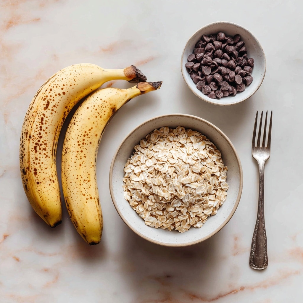 A clear glass bowl sits on a white marbled surface, containing a single layer of mashed bananas. The mashed bananas are pale yellow with small lumps and a soft, creamy texture, scattered evenly in the center of the bowl. The surface of the mixture has tiny darker specks, likely from the banana skin or seeds. The scene is bright, with natural light illuminating the bowl and its contents, creating a fresh and simple atmosphere. photo taken with an iphone --ar 4:5 --v 7