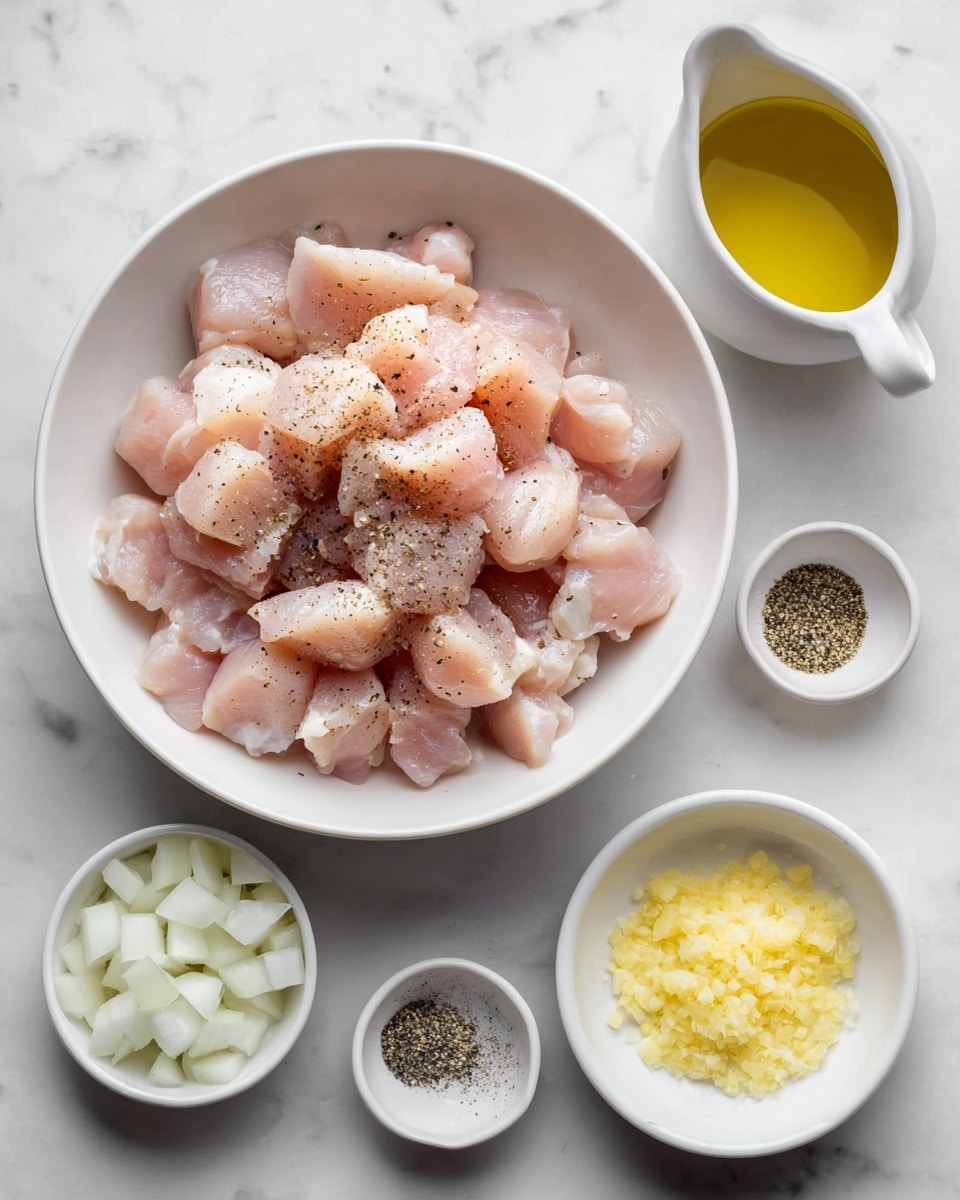 A white bowl in the center filled with small pieces of light pink chicken seasoned with black pepper. Around the bowl, on a white marbled surface, there are small white dishes containing chopped white onions at the lower left, crushed yellow garlic at the lower right, black pepper and salt at the upper right, and golden yellow olive oil in a white bowl with a handle at the upper left. The arrangement is neat and ingredients are separated clearly. Photo taken with an iphone --ar 4:5 --v 7