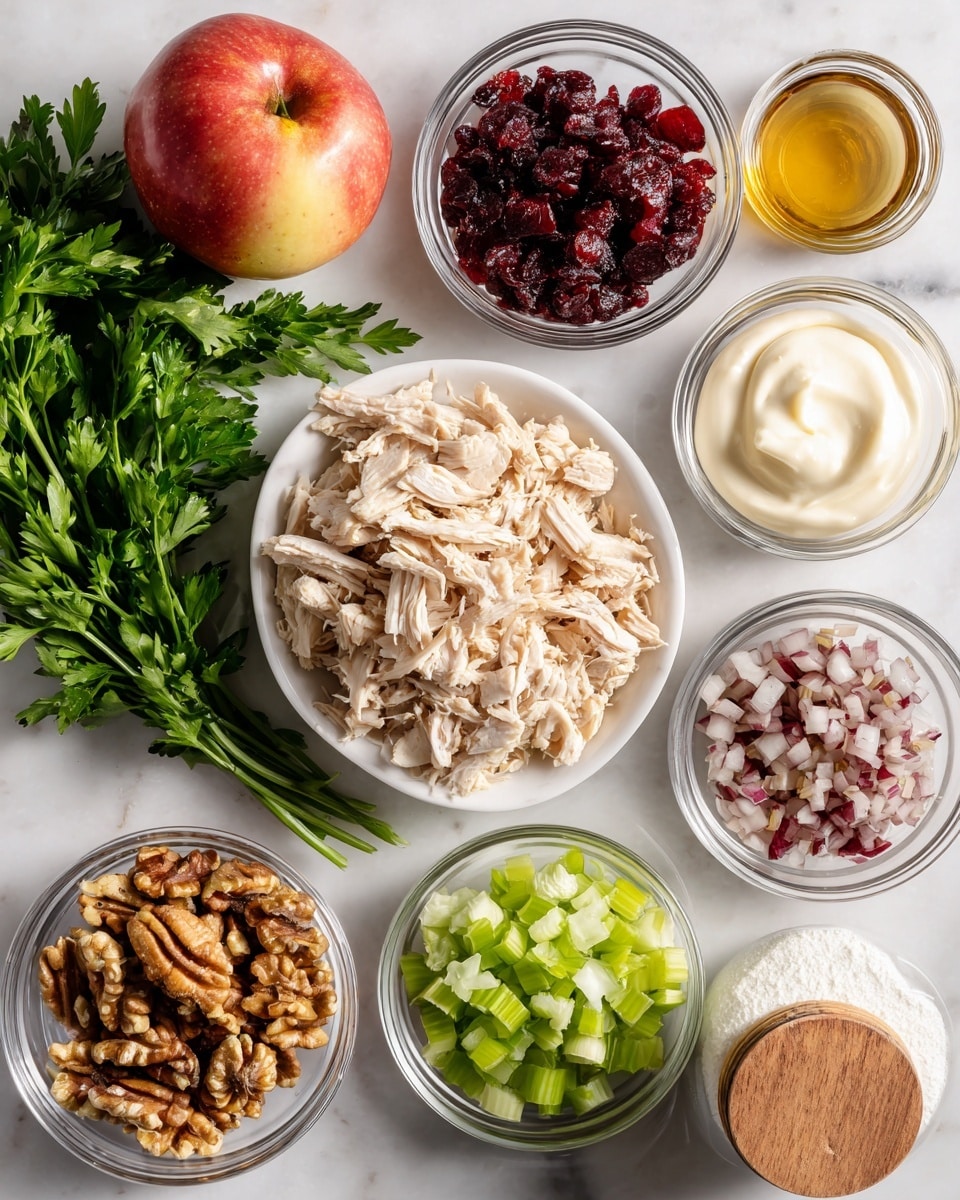 A top-down view of a white marbled surface with several small clear glass bowls and one white dish arranged neatly, each holding a different ingredient: shredded light beige chicken in the center, chopped light green celery at the bottom right, finely chopped red onion at the top right, chopped brown walnuts to the right center, dark red dried cranberries at the top left, a dollop of creamy white mayo near the top center, and a small amount of yellow mustard in a tiny white dish below the cranberries. A bunch of fresh green parsley is placed at the bottom left, next to a small glass bowl with light brown vinegar. A red and yellow apple is positioned near the top center, and a white jar with a wooden lid containing white powder is on the far right. Photo taken with an iphone --ar 4:5 --v 7