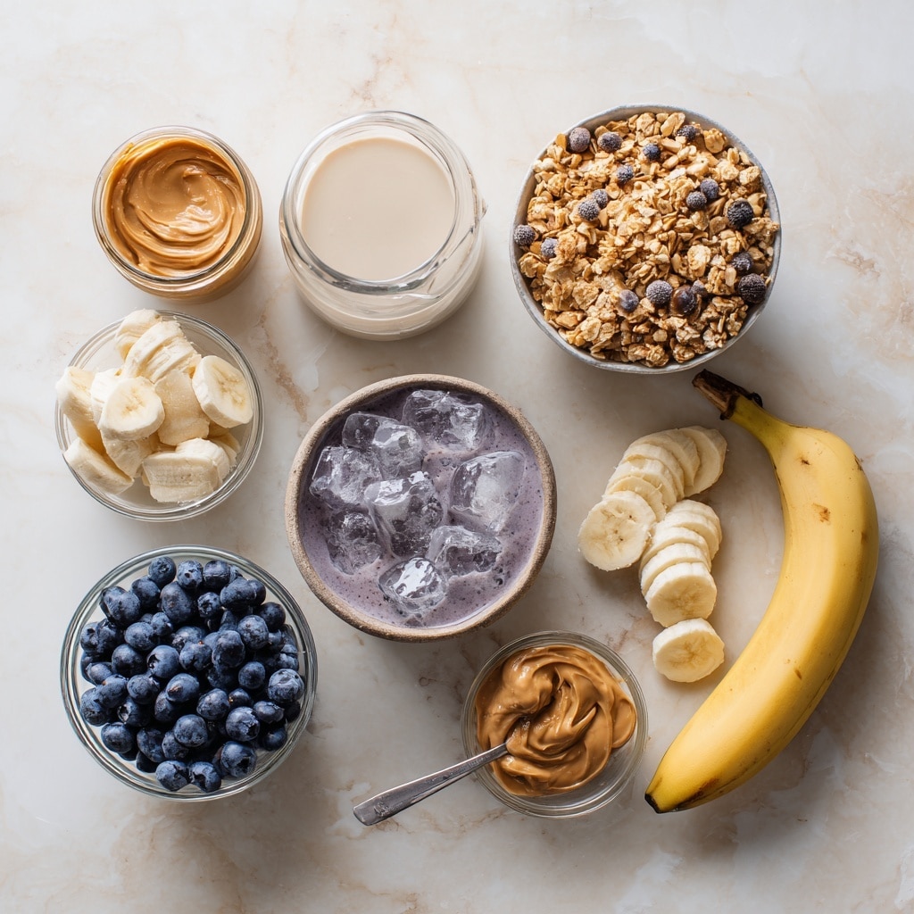 A tall clear glass filled with a thick, smooth dark purple smoothie that reaches the top edge. The smoothie is topped with a small pile of light brown granola that has oat clusters and thin almond slices, several fresh dark blue blueberries scattered on top, and two banana slices with a light cream color, placed near one side. Light brown peanut butter is drizzled over the granola, banana slices, and blueberries, creating a shiny contrast. The glass sits on a white marbled surface with a soft, blurred background. Photo taken with an iphone --ar 4:5 --v 7