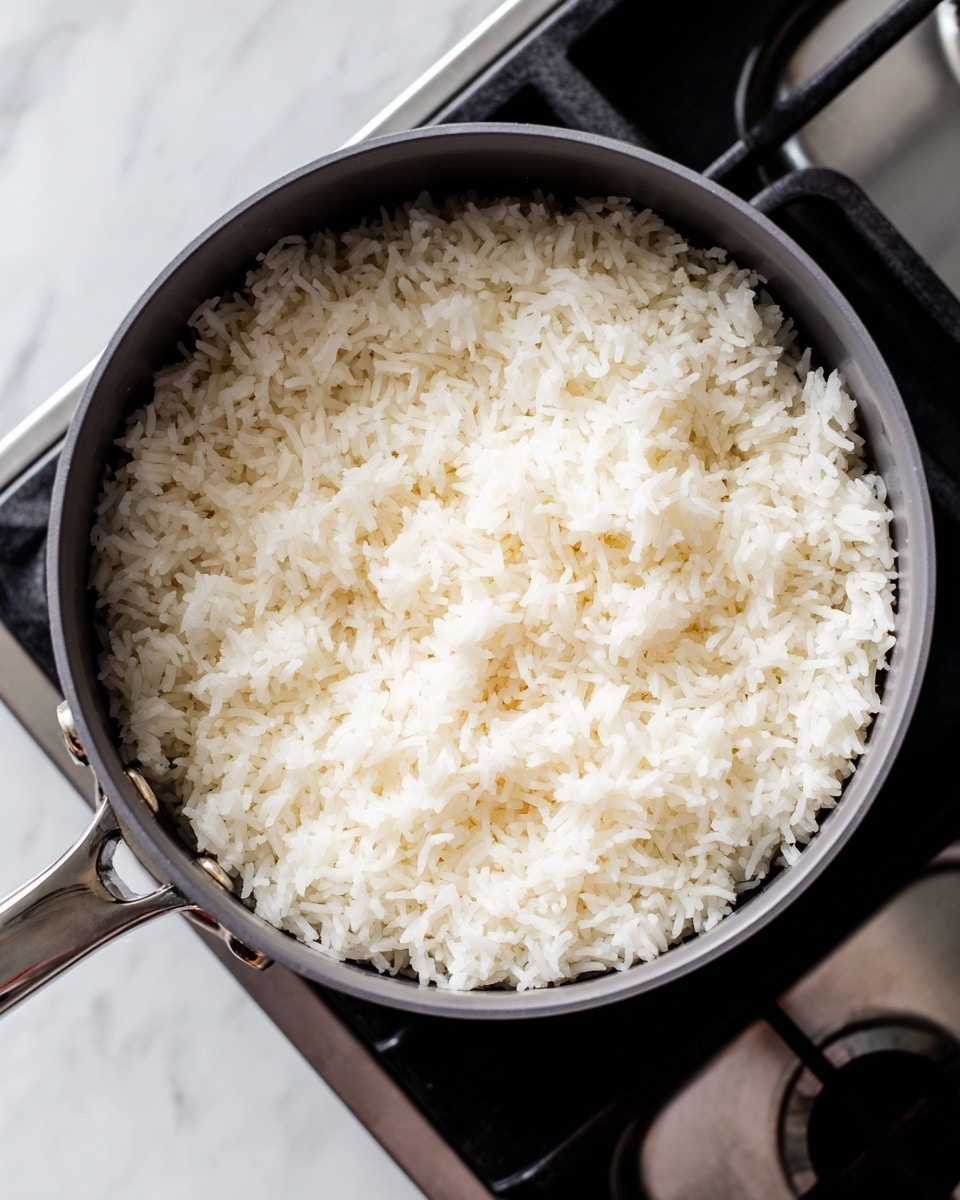 A close-up image shows several raw white shrimp placed inside a silver metal colander with small round holes. The shrimp are curved, translucent, and have a slightly shiny surface, arranged loosely at the center with some overlapping. The metal colander is held above a surface with soft, diffused light creating subtle reflections on the shrimp and colander. The background is a white marbled texture. Photo taken with an iphone --ar 4:5 --v 7