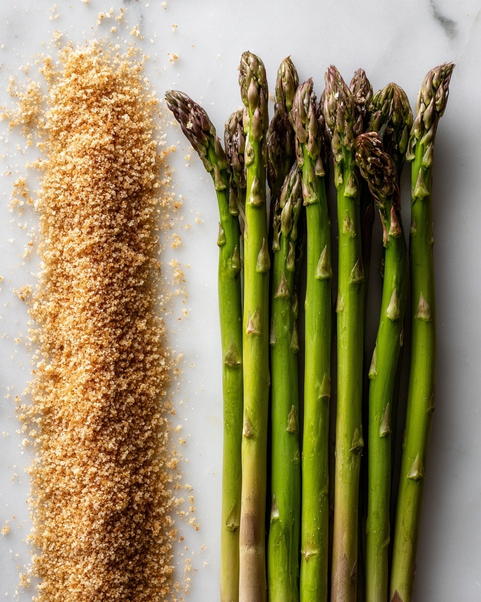 The image shows two sections on a white marbled surface. The left side has a thin, even layer of small, golden-brown crumbs spread out, appearing slightly rough and dry in texture. The right side has a neat row of eleven fresh green asparagus stalks placed parallel and evenly spaced, with darker green tips and lighter green stalks that look smooth and firm. The composition balances the crumb texture on the left with the fresh vegetables on the right, all brightly lit. photo taken with an iphone --ar 4:5 --v 7