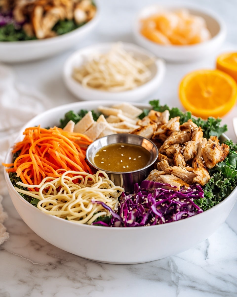 On a silver tray with a white marbled texture background, there is a large clear glass bowl filled with chopped green kale leaves on the top right and another clear glass bowl with chopped light green lettuce on the top left. Below the lettuce bowl is a whole bright orange orange. To the right of the orange, there is a small clear glass bowl with white and light brown powders. Toward the center right, a white bowl holds several raw pink chicken pieces. Next to the chicken bowl on the right is a small white scalloped dish filled with light brown powder. In the lower center, a small white bowl contains light brown crunchy sticks. Surrounding the crunchy sticks, small white bowls hold dark brown sauces, bright orange shredded carrots, white sesame seeds, and shredded purple cabbage. A small white cup with light green liquid is near the bottom left. Resting on the tray among the bowls is a small spoon with a wood and metal handle, holding a yellow paste. photo taken with an iphone --ar 4:5 --v 7