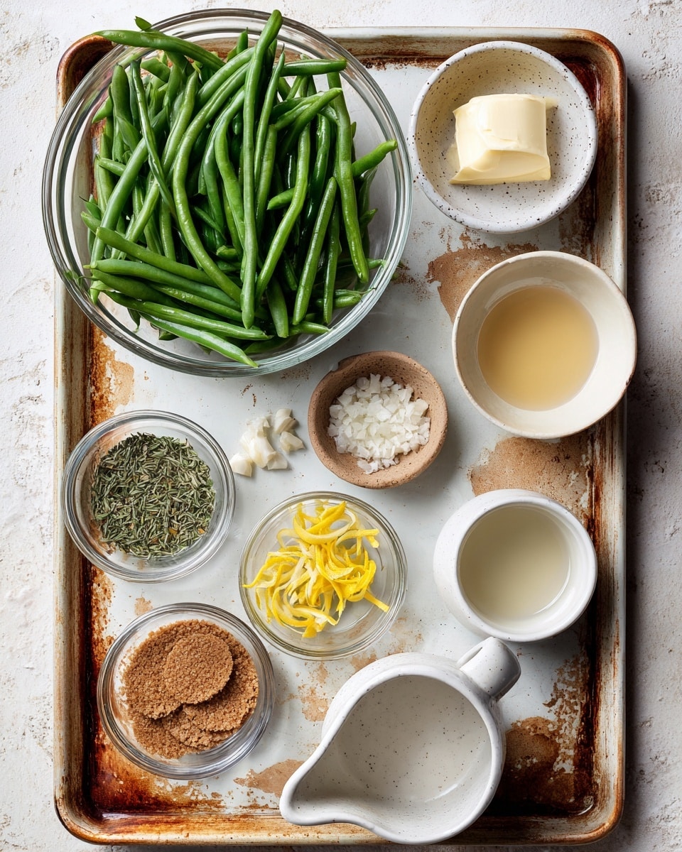 A large clear glass bowl filled with fresh green beans sits on the top left of a well-used baking tray with rusty orange and brown marks. To its right, a white speckled small bowl holds a dollop of butter. Below this, a white speckled bowl contains a pale yellow liquid, and next to it on the bottom right corner, a white bowl holds a clear liquid. Moving leftwards, a small bowl with finely chopped garlic sits near the center above another white speckled bowl with green dried herbs. Two small clear bowls with bright yellow lemon zest shards are positioned just below and to the right of the herb bowl. A clear glass bowl with three brown circular breadcrumbs piles is in the bottom left corner, next to it a bowl with a pat of butter and a white ceramic pitcher filled with a light beige liquid complete the scene. All items rest on a white marbled textured surface. Photo taken with an iphone --ar 4:5 --v 7