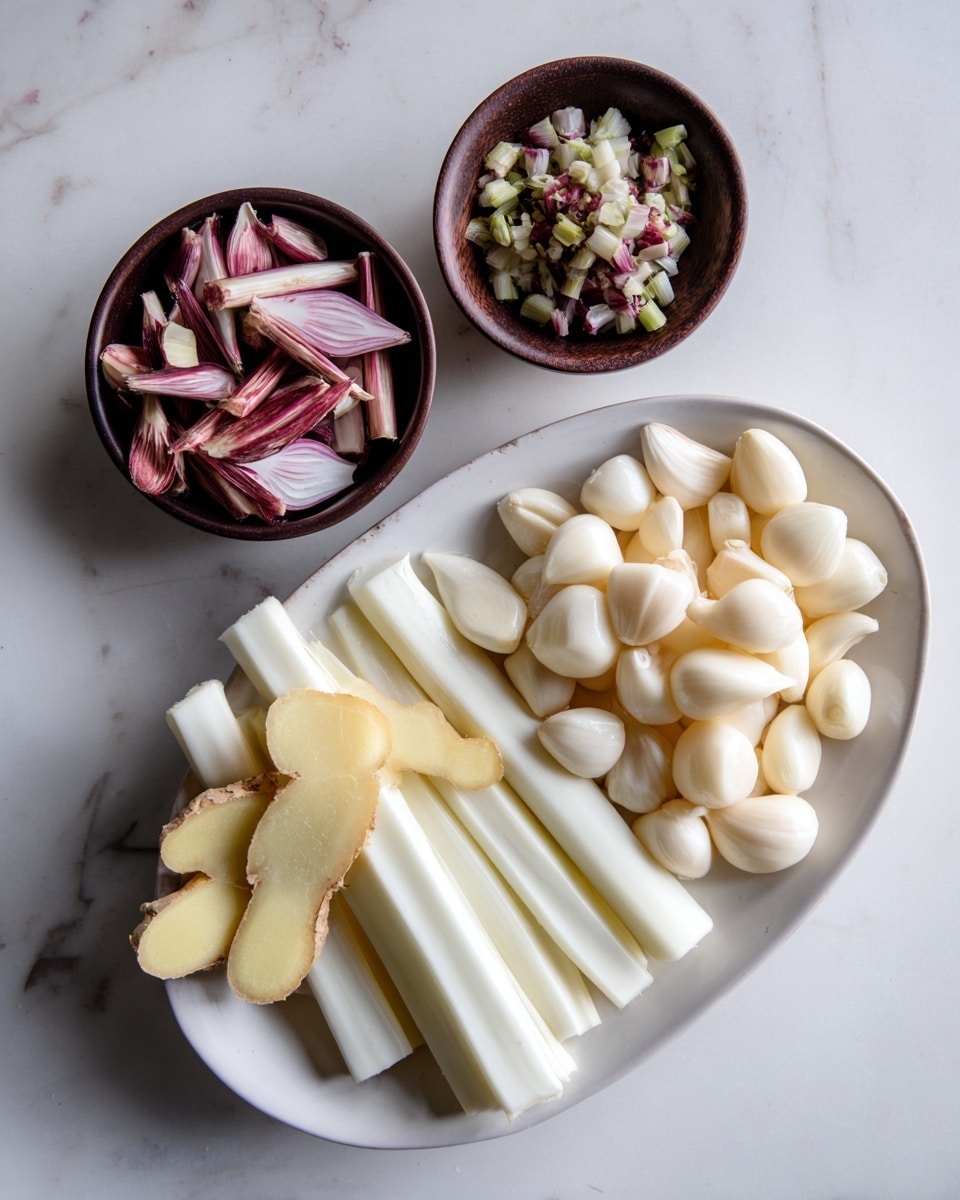 A white oval bowl sits on a white marbled surface, filled with several layers of fresh ingredients. On the right, there is a pile of whole peeled garlic cloves, off-white and smooth with a few ridges. Below and nearby are several long pieces of peeled white shallots, arranged parallel to each other showing their layered texture. To the left of the garlic, there are several slightly curved pale yellow slices of ginger with rougher edges. A small dark brown bowl sits in the top left corner of the white bowl, filled with small slices of pale purple and white lemongrass and chopped green and white pieces, giving a mix of soft colors and textures. photo taken with an iphone --ar 4:5 --v 7