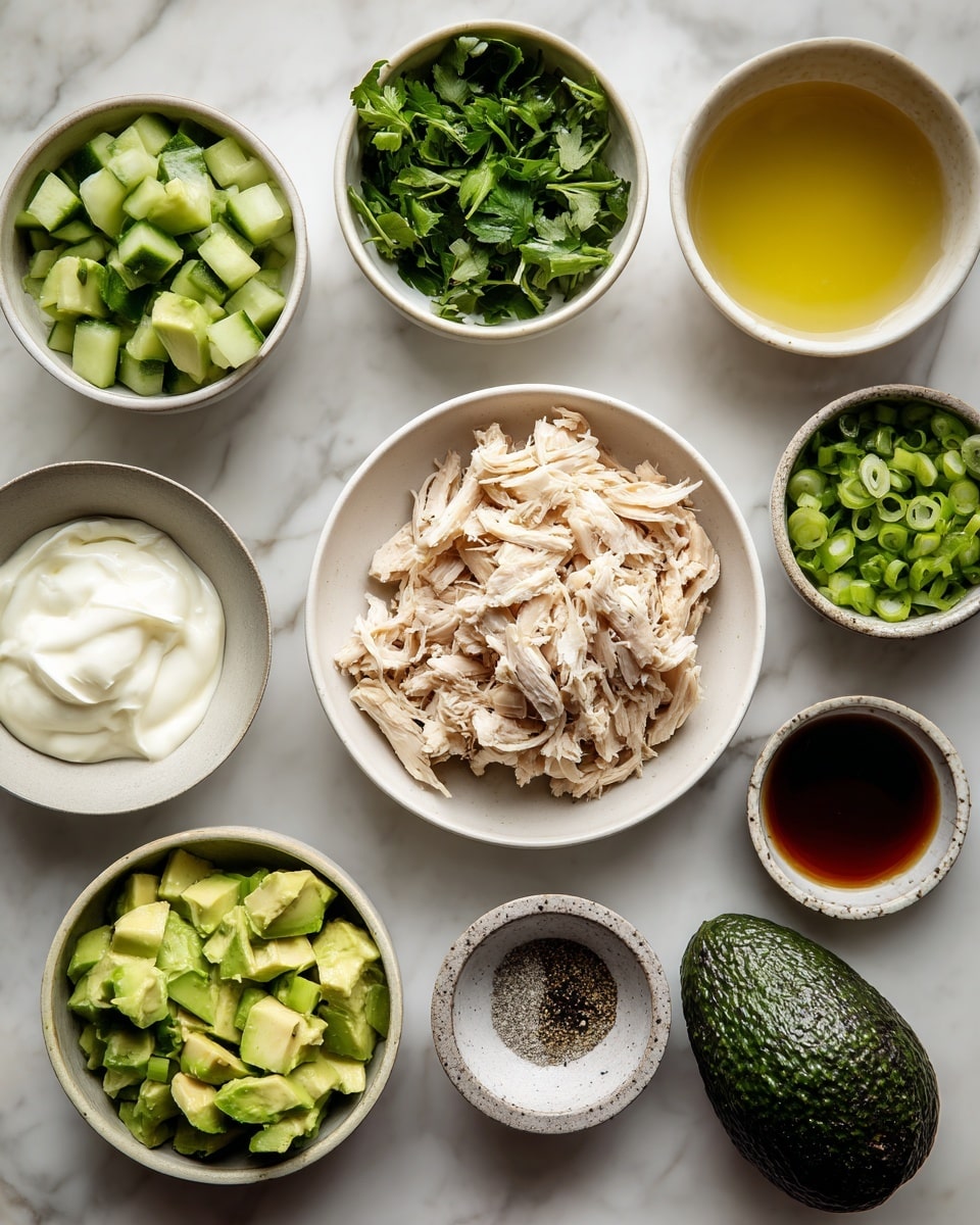 The image shows nine white bowls and a whole avocado placed neatly on a white marbled surface. The center bowl holds a pile of shredded light beige cooked chicken. Surrounding it are bowls with small green cucumber cubes, chopped fresh green herbs, chopped dark green spring onions, thick white yogurt, a clear light yellow liquid, a dark golden brown liquid, light beige powder, and a mix of black and white ground spices in a small marble bowl. The whole avocado is dark green and textured, placed near the yogurt bowl. Each item is clearly separated, showing a variety of fresh and creamy textures. Photo taken with an iphone --ar 4:5 --v 7