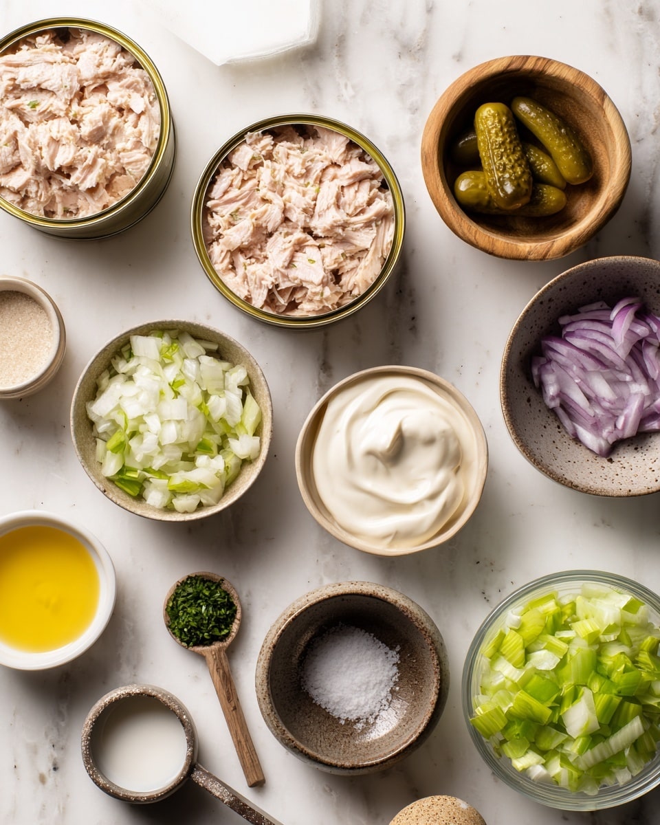 The image shows a flat lay of various ingredients arranged neatly on a white marbled surface. There are two open tin cans containing light beige tuna, positioned on the left side. To the right, small bowls hold different ingredients: a beige bowl with white creamy mayonnaise, a wooden bowl with chopped light purple onions, a brown speckled bowl with green chopped pickles, and a small dark brown bowl with finely chopped green herbs. Also included are a small wooden bowl with white salt mixed with pepper, a small white dish with yellow mustard, a white speckled dish with a clear liquid, a metal measuring cup filled with light green chopped celery, and a glass measuring cup containing thick white yogurt. Each ingredient is clearly visible with distinct colors and textures on the white marbled background. photo taken with an iphone --ar 4:5 --v 7