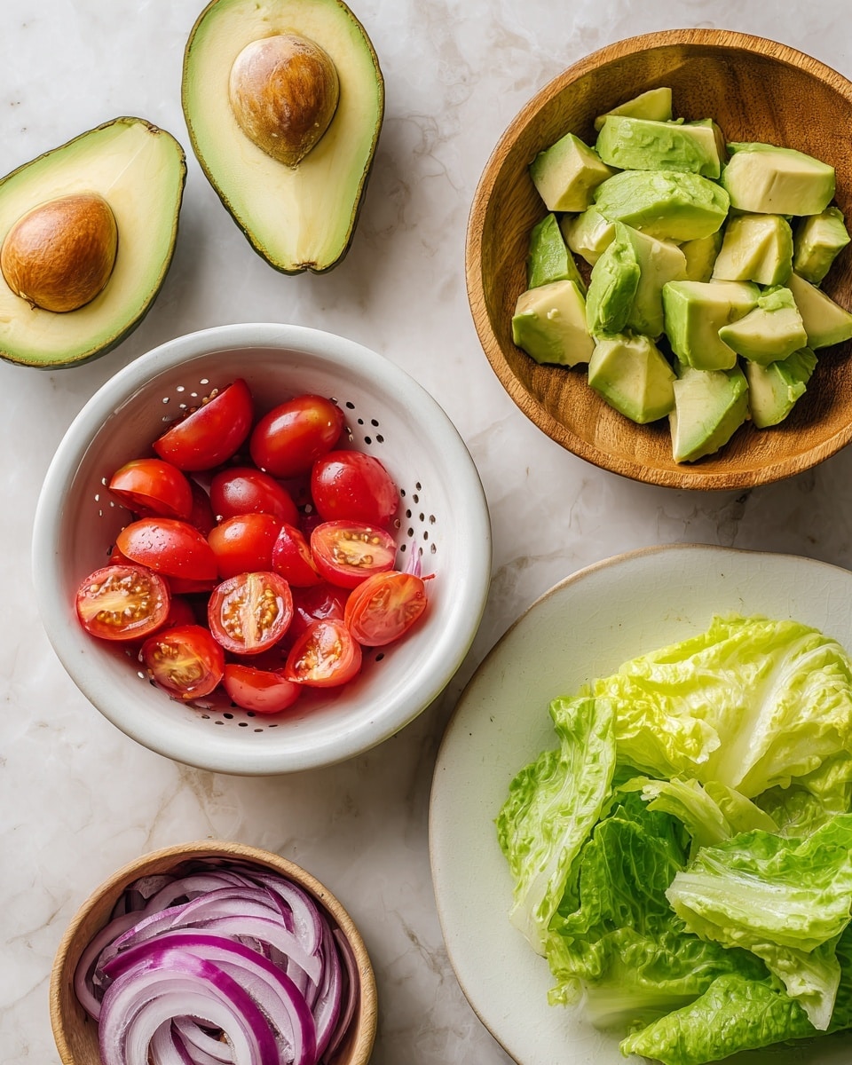 The image shows an overhead view of several salad ingredients arranged on a white marbled textured surface. On the top left, there are two halved avocados with their brown seeds in the center, showing light green and yellow flesh. Below that is a wooden bowl filled with sliced avocado pieces, bright green with smooth texture. In the middle left, there is a white colander filled with halved cherry tomatoes, bright red with juicy, glossy surfaces. On the top right, a small wooden bowl holds thinly sliced red onion rings, purple with white accents and soft curves. At the bottom right, a white plate contains torn fresh green lettuce leaves with crisp textures and light color variation between dark and pale green. Photo taken with an iphone --ar 4:5 --v 7