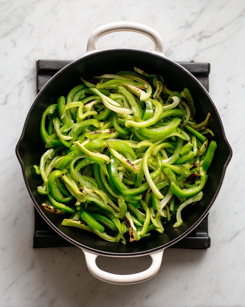 The image shows a black cast iron pan with white handles on a stove with black grates. Inside the pan, there are about twenty pieces of green bell pepper strips being cooked. The peppers have a mix of bright green colors with some darker, lightly browned spots. The pan sits on a white marbled surface that is clean and bright. The photo is clear and natural, giving a fresh and simple look. photo taken with an iphone --ar 4:5 --v 7