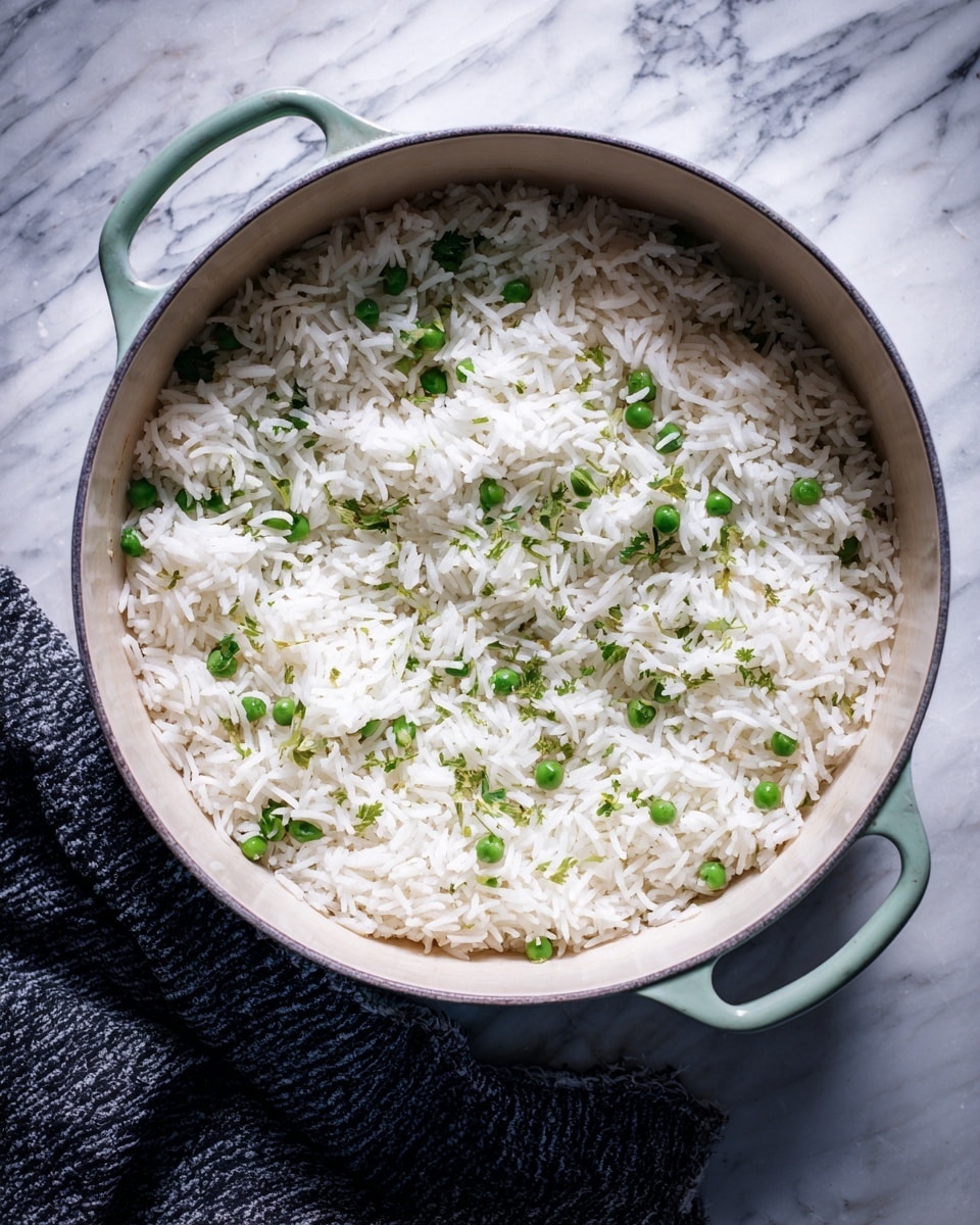 A light green pot filled with a mix of white cooked rice and green peas evenly spread across the surface. The rice grains are fluffy and soft, while the peas add a pop of bright green color, creating a simple contrast. The pot rests on a white marbled surface, and a textured dark cloth is partially visible next to the pot. photo taken with an iphone --ar 4:5 --v 7