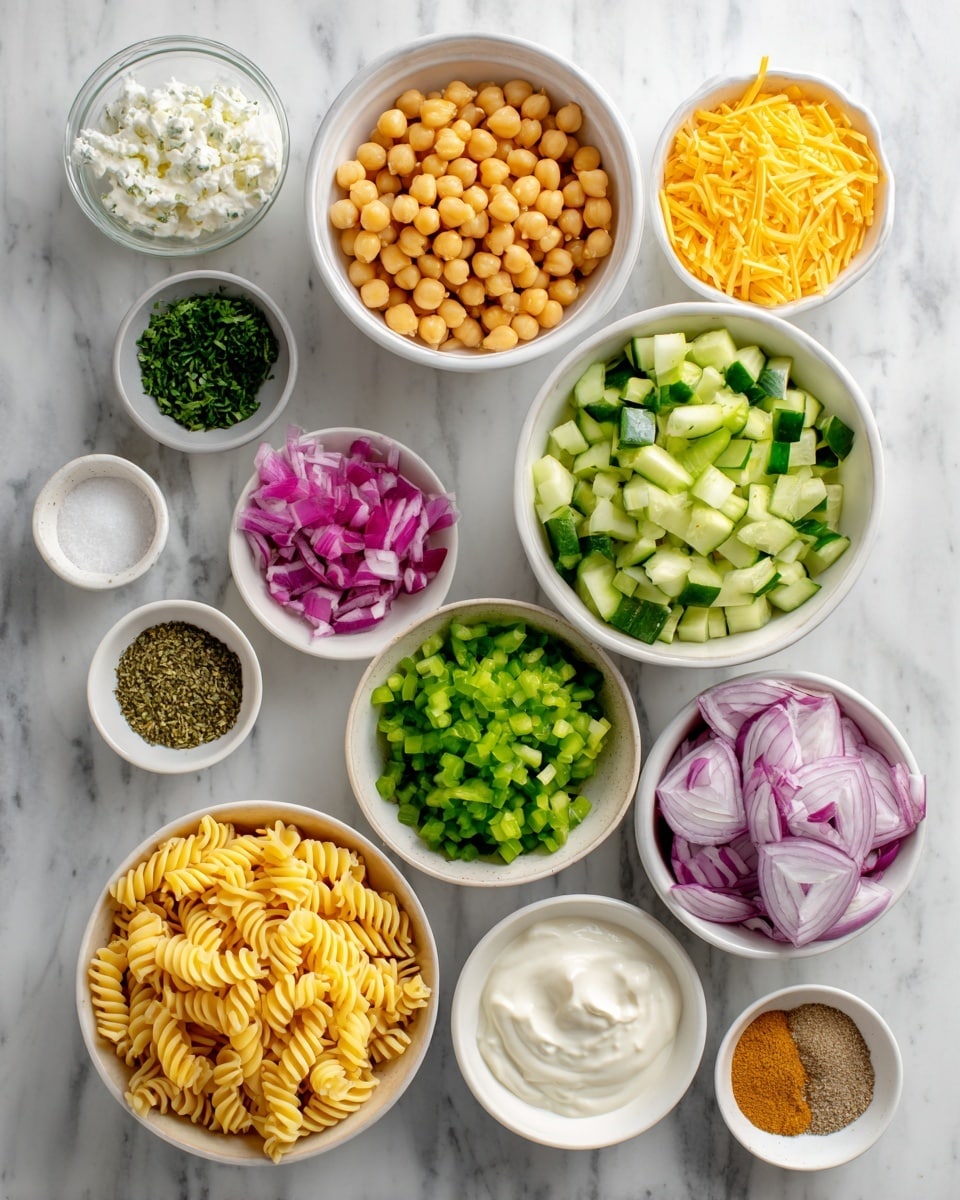The image shows several small white bowls arranged neatly on a white marbled surface, each holding different ingredients. There are golden chickpeas in one bowl and light yellow spiral pasta in another. Around them are bowls with chopped green cucumbers, diced green celery, diced yellow-green pickles, shredded bright orange cheddar cheese, and finely chopped red onions. Other smaller bowls contain fresh green herbs, green dried herbs, light brown and beige powders, white creamy mayonnaise-like dressing, white thick yogurt, clear olive oil, light yellow lemon juice, white salt, and light beige ground pepper. The arrangement is clean and colorful, with each ingredient clearly visible. Photo taken with an iphone --ar 4:5 --v 7