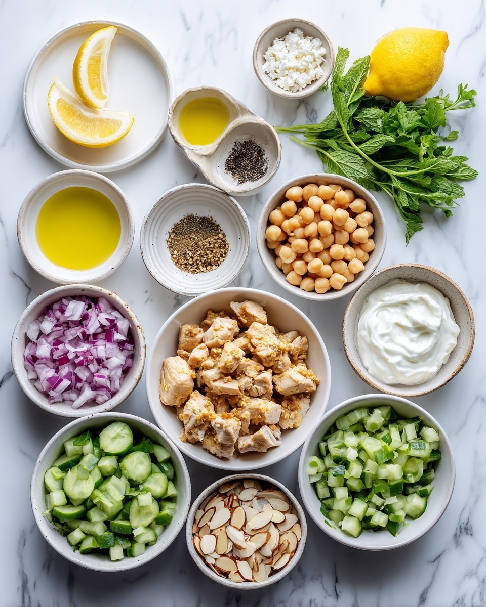 A collection of small white bowls arranged on a white marbled surface, each filled with different ingredients. The main bowl in the center contains light golden chunky pieces of cooked chicken. Around it, clockwise from top left, there are fresh green herbs, lemon wedges, a small bowl of black pepper, a bowl filled with light brown chickpeas, a bowl of thick white yogurt, a bowl of finely chopped red onion, a bowl with white cottage cheese, a bowl filled with green diced cucumbers, and a bowl with sliced almonds. Two small bowls with yellow and pale yellow liquids sit on a white plate near the top left. The overall look is fresh and colorful, with a bright, natural light. Photo taken with an iphone --ar 4:5 --v 7