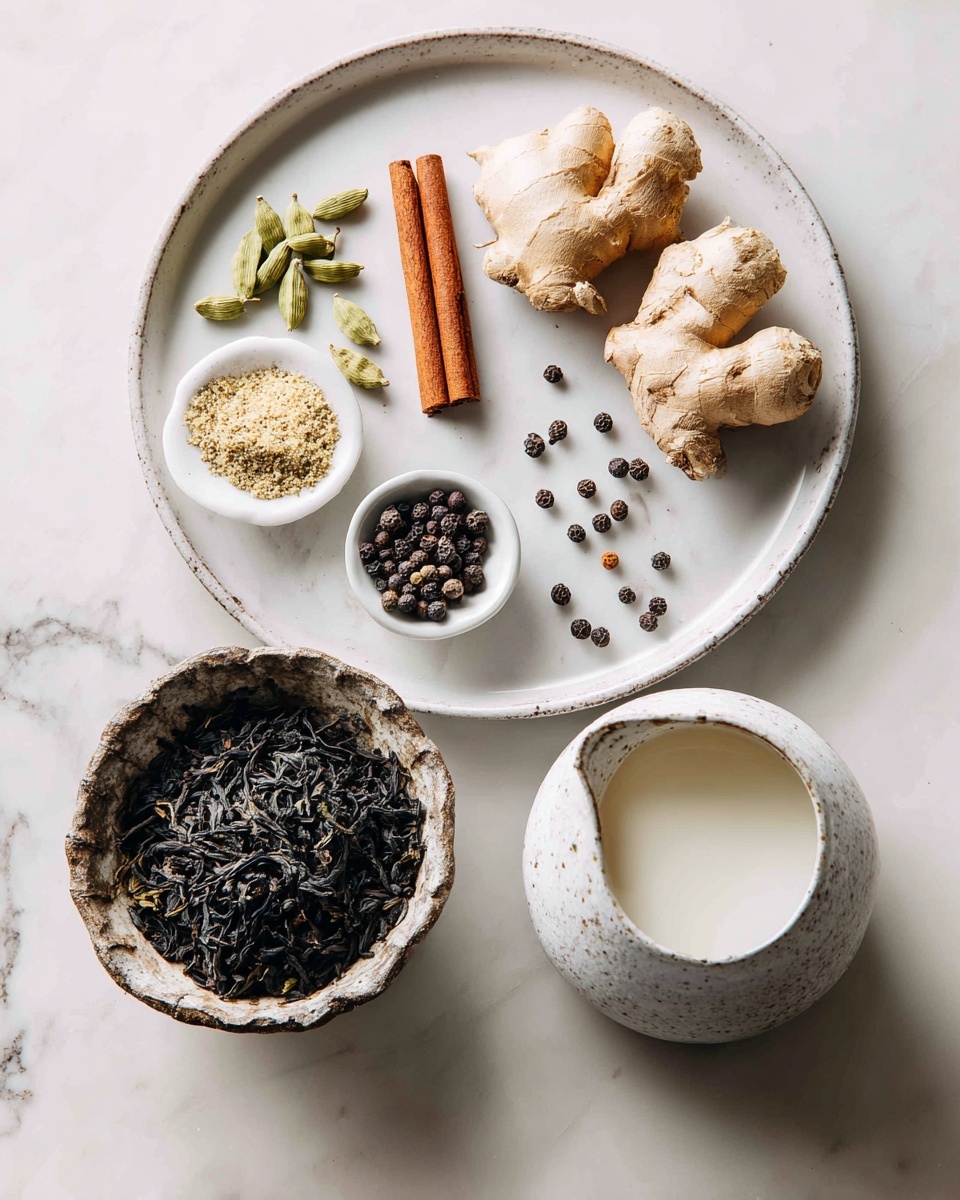 The image shows a white round plate on a white marbled surface holding a cinnamon stick, green cardamom pods, two pieces of fresh ginger, a small pile of salt in a tiny bowl, whole cloves, and black peppercorns scattered in small groups. Below the plate on the marbled surface, there is a rustic bowl filled with loose dark tea leaves, and to the right, a white speckled small pitcher containing milk. The arrangement is clean and bright with natural light. Photo taken with an iphone --ar 4:5 --v 7