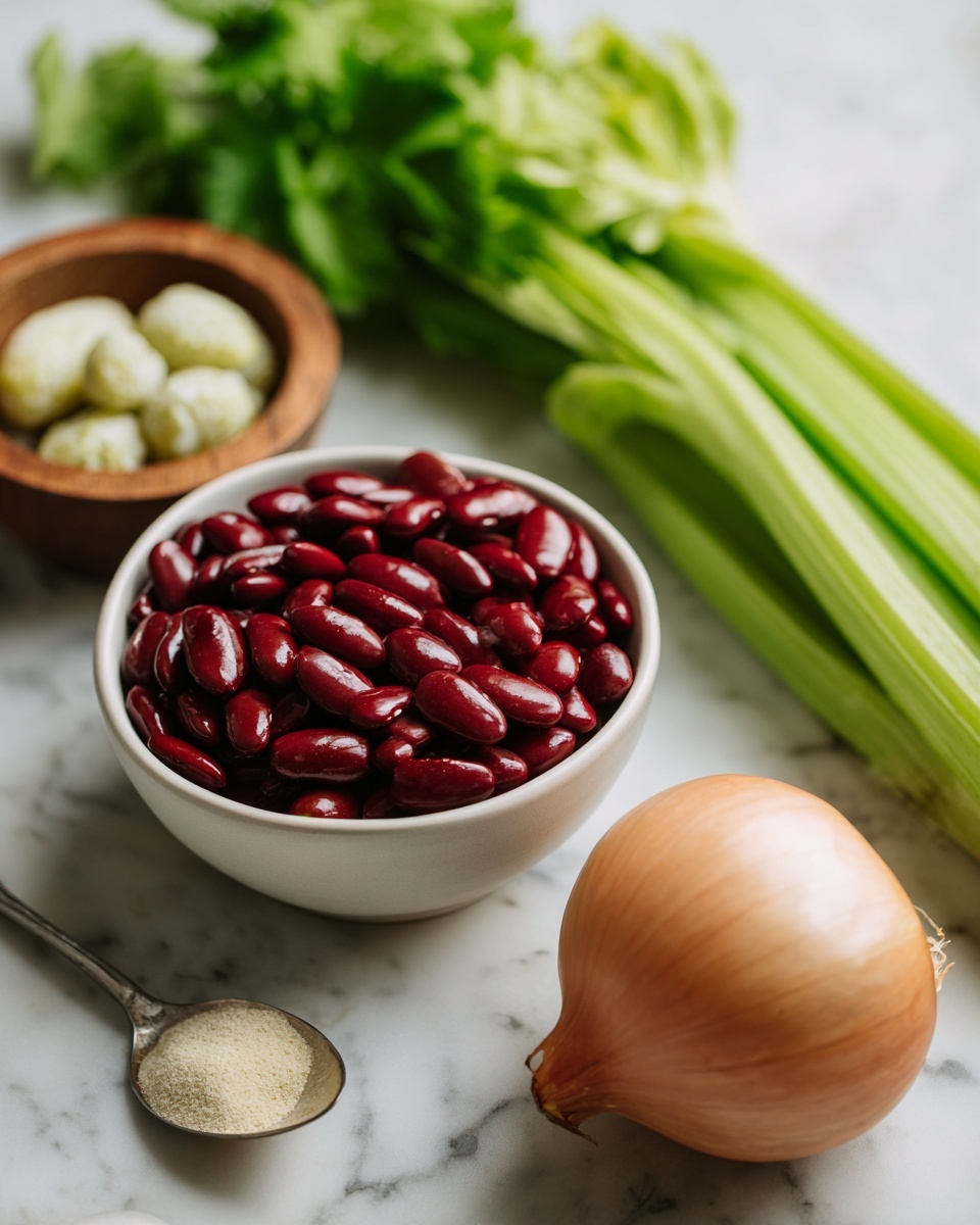 A white bowl filled with shiny red kidney beans takes the front left of the image. To the right, a smaller white bowl holds several dark green pickles, textured with small bumps. Behind the beans, a thick bunch of fresh green celery with leafy tops leans to the right. To the right of the celery, a whole round onion with light brown skin sits on a white marbled surface. In the background, a small wooden bowl contains a dollop of light cream, and a metallic spoon with a beige powder rests in front on the surface. Soft light brightens the fresh ingredients with a natural, homey feel photo taken with an iphone --ar 4:5 --v 7